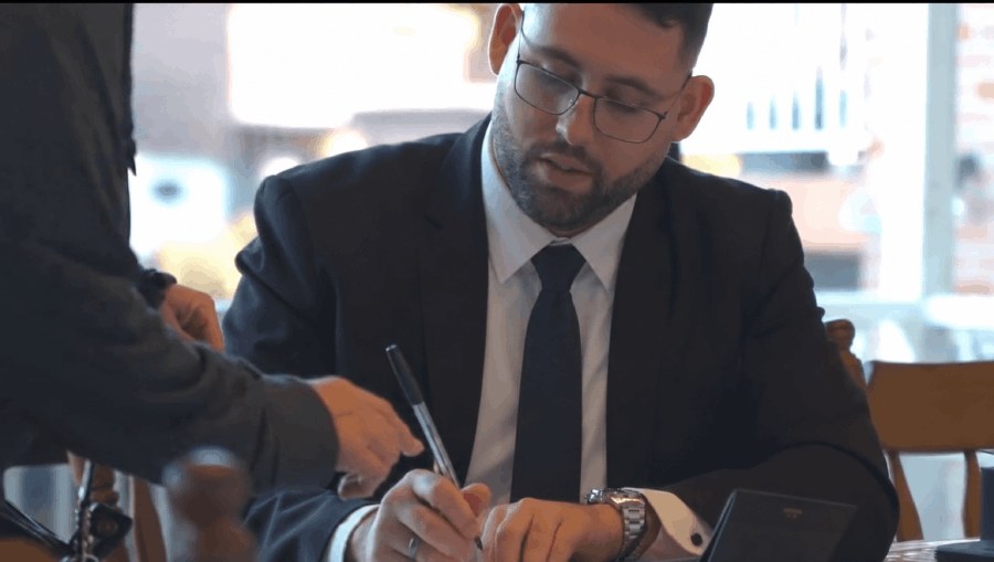 Bayline Property Group agent signing a contract with a client